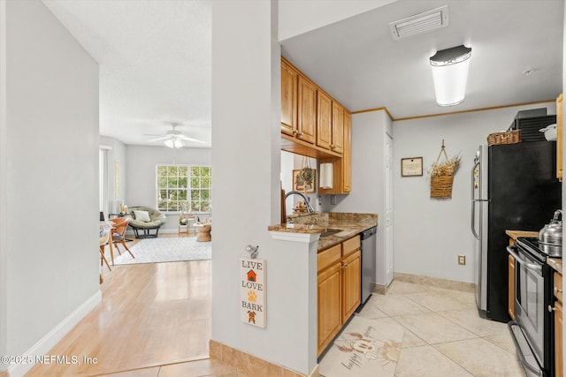 4000 Grande Vista Blvd Unit 15-206, Saint Augustine, FL 32084 - kitchen featuring appliances with stainless steel finishes, ceiling fan, open floor plan, and light tile patterned flooring