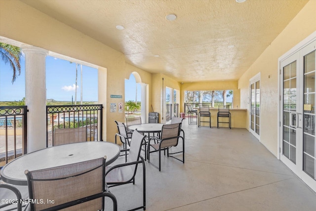 4000 Grande Vista Blvd Unit 15-206, Saint Augustine, FL 32084 - sunroom featuring outdoor dining area, concrete floors, a textured ceiling, and recessed lighting