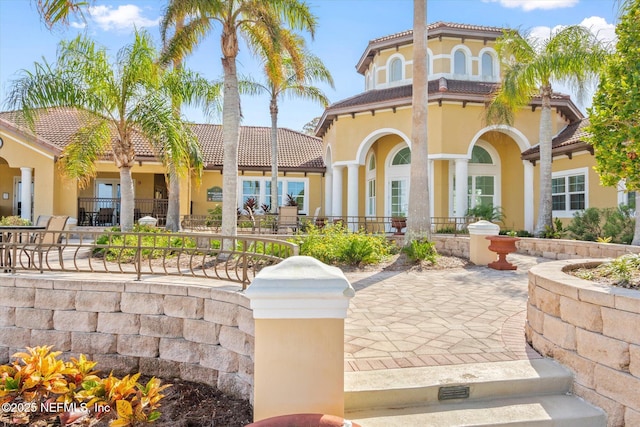 4000 Grande Vista Blvd Unit 15-206, Saint Augustine, FL 32084 - back of house featuring stucco siding and a tile roof