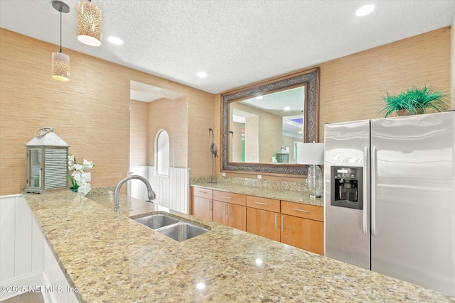 4000 Grande Vista Blvd Unit 15-206, Saint Augustine, FL 32084 - kitchen with stainless steel refrigerator with ice dispenser, light stone countertops, a textured ceiling, and pendant lighting
