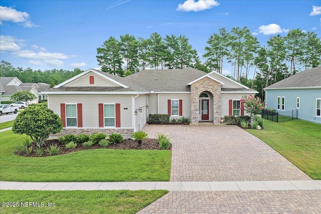 17 Derecho Ln, Saint Augustine, FL 32095 - view of front facade featuring stone siding, an attached garage, and decorative driveway