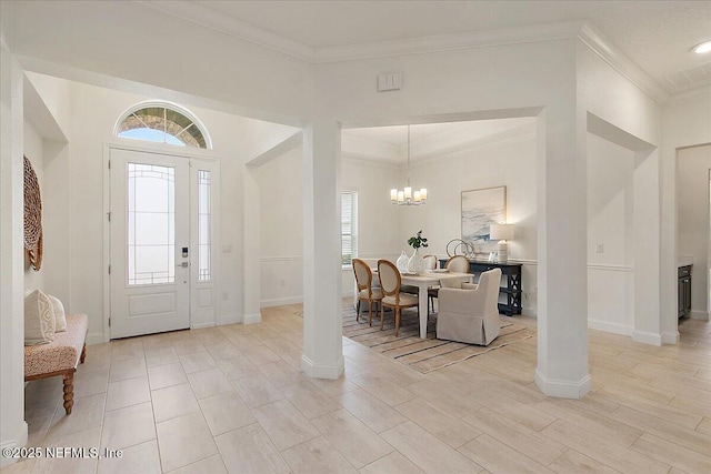 17 Derecho Ln, Saint Augustine, FL 32095 - foyer entrance with crown molding, a chandelier, and light wood finished floors
