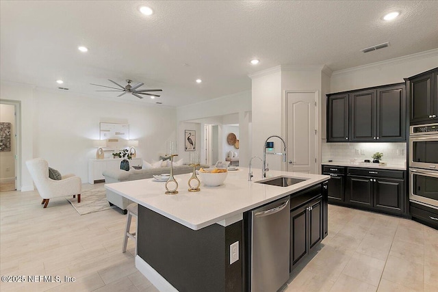 17 Derecho Ln, Saint Augustine, FL 32095 - kitchen featuring stainless steel appliances, open floor plan, dark cabinets, light countertops, and tasteful backsplash