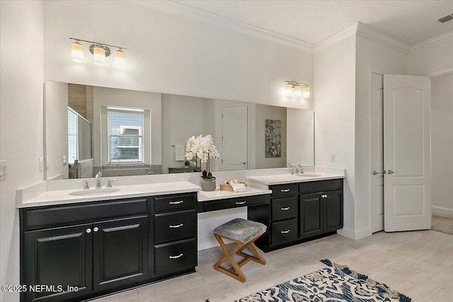 17 Derecho Ln, Saint Augustine, FL 32095 - bathroom with two vanities, a shower with door, and ornamental molding
