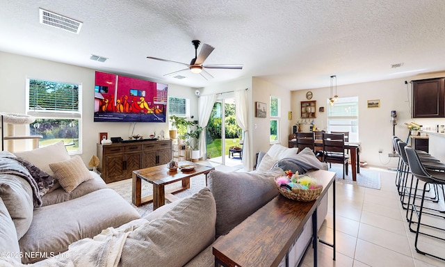 8657 Lake George Cir E, Macclenny, FL 32063 - living area featuring ceiling fan, a textured ceiling, and light tile patterned flooring
