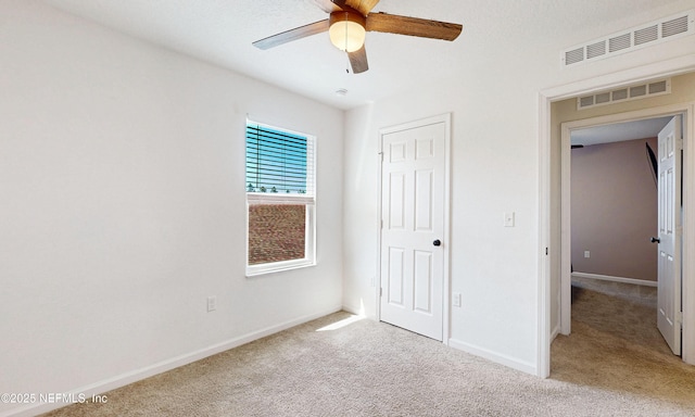 8657 Lake George Cir E, Macclenny, FL 32063 - unfurnished bedroom featuring light colored carpet, a closet, and a ceiling fan