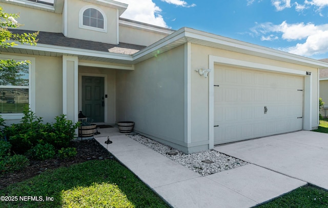 8657 Lake George Cir E, Macclenny, FL 32063 - view of front of property featuring stucco siding, a garage, and driveway