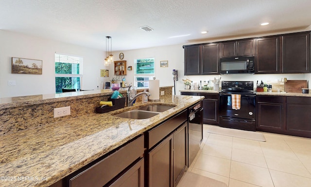 8657 Lake George Cir E, Macclenny, FL 32063 - kitchen with black appliances, light stone countertops, hanging light fixtures, dark brown cabinets, and recessed lighting