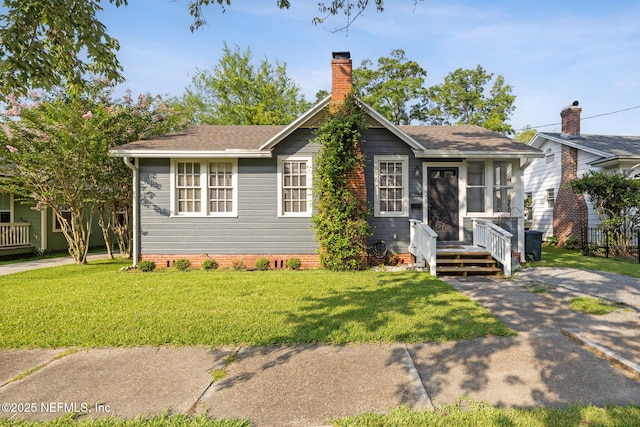 1094 Wolfe St, Jacksonville, FL 32205 - view of front of property with a front lawn, a chimney, and a shingled roof