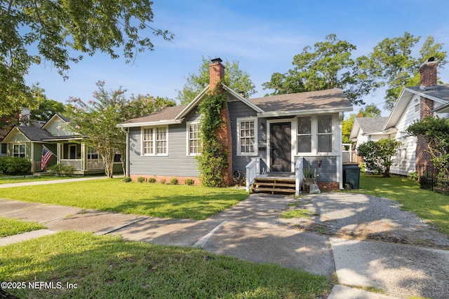 1094 Wolfe St, Jacksonville, FL 32205 - view of front of home with a front yard and a chimney