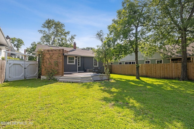 1094 Wolfe St, Jacksonville, FL 32205 - back of property featuring a fenced backyard, a deck, a gate, and a chimney