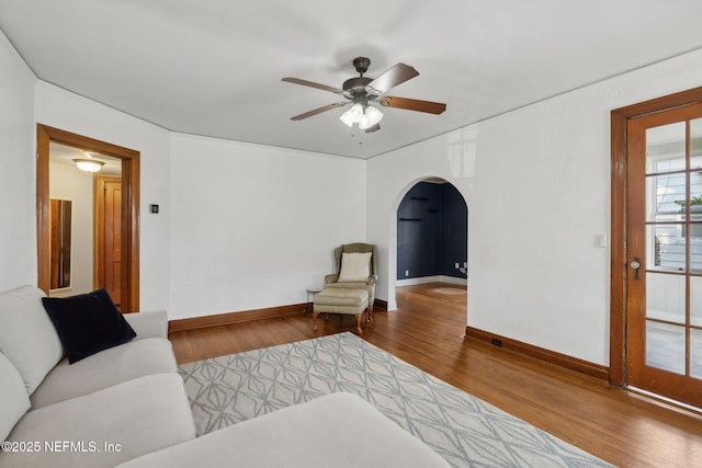 1094 Wolfe St, Jacksonville, FL 32205 - unfurnished living room with arched walkways, wood finished floors, and ceiling fan
