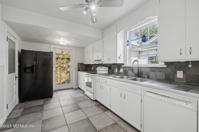 1094 Wolfe St, Jacksonville, FL 32205 - kitchen featuring white appliances, tasteful backsplash, white cabinets, and tile counters