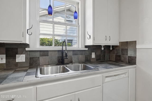1094 Wolfe St, Jacksonville, FL 32205 - kitchen with white dishwasher, white cabinetry, and tasteful backsplash