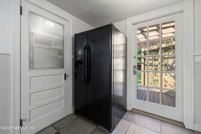 1094 Wolfe St, Jacksonville, FL 32205 - kitchen featuring black fridge and light tile patterned floors