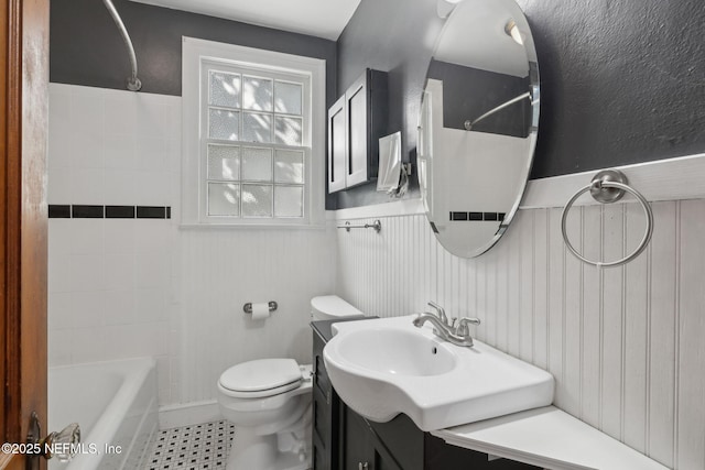 1094 Wolfe St, Jacksonville, FL 32205 - full bath featuring wainscoting, shower / tub combination, vanity, and tile patterned floors