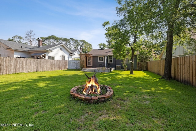 1094 Wolfe St, Jacksonville, FL 32205 - fenced backyard with an outdoor fire pit and a wooden deck