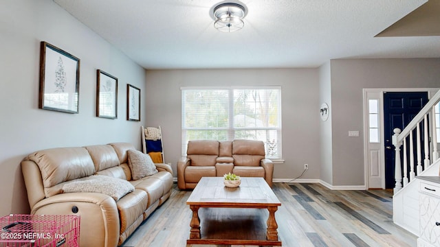 1441 Laurel Oak Dr, Fleming Island, FL 32003 - living area featuring light wood-style flooring, stairway, and baseboards
