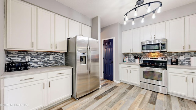 1441 Laurel Oak Dr, Fleming Island, FL 32003 - kitchen featuring appliances with stainless steel finishes, light countertops, and tasteful backsplash