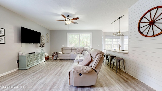 1441 Laurel Oak Dr, Fleming Island, FL 32003 - living room featuring ceiling fan, light wood finished floors, wooden walls, and baseboards