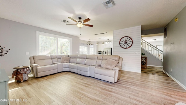 1441 Laurel Oak Dr, Fleming Island, FL 32003 - living room with a ceiling fan, light wood-style floors, stairs, and baseboards
