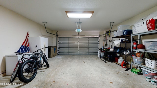 1441 Laurel Oak Dr, Fleming Island, FL 32003 - garage featuring freestanding refrigerator and a garage door opener
