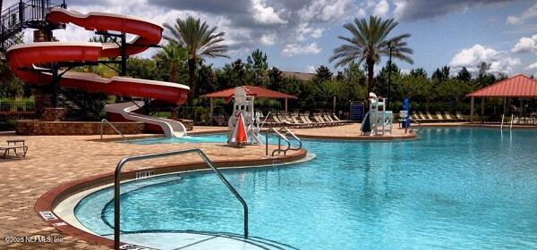 1441 Laurel Oak Dr, Fleming Island, FL 32003 - community pool featuring a water slide and a patio area