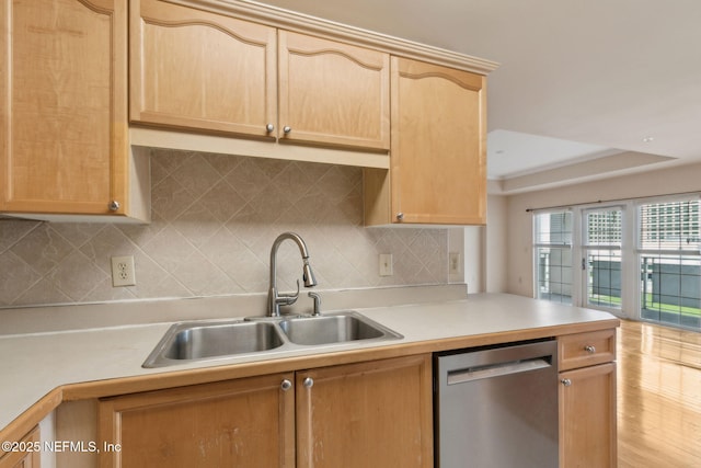 400 E Bay St Unit 401, Jacksonville, FL 32202 - kitchen with stainless steel dishwasher, light brown cabinetry, light countertops, and decorative backsplash
