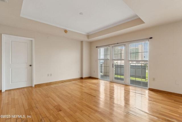 400 E Bay St Unit 401, Jacksonville, FL 32202 - empty room with a tray ceiling, light wood-style floors, and crown molding
