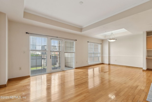 400 E Bay St Unit 401, Jacksonville, FL 32202 - empty room with a raised ceiling, healthy amount of natural light, ornamental molding, and light wood-type flooring