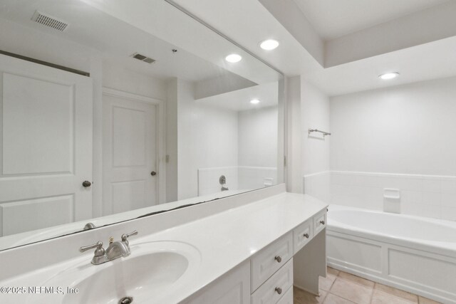 400 E Bay St Unit 401, Jacksonville, FL 32202 - bathroom with vanity, recessed lighting, a garden tub, and tile patterned floors