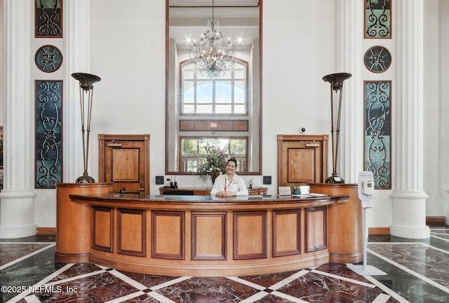 400 E Bay St Unit 401, Jacksonville, FL 32202 - reception with decorative columns, a high ceiling, and a chandelier