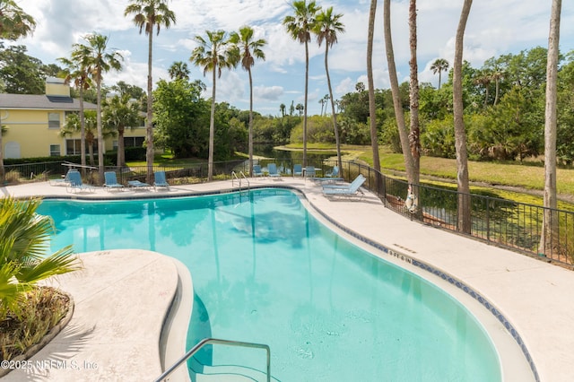 1800 The Greens Way Unit 603, Jacksonville Beach, FL 32250 - community pool featuring view of scattered trees, a patio area, and a water view