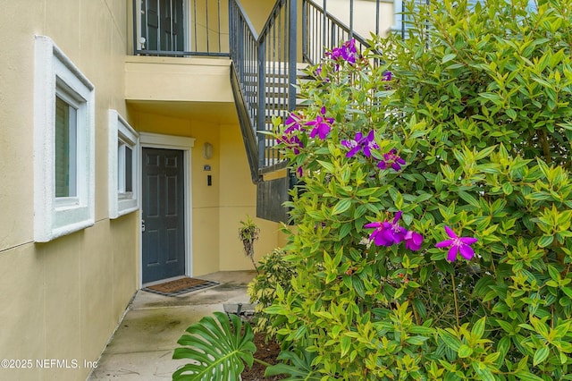 1800 The Greens Way Unit 603, Jacksonville Beach, FL 32250 - doorway to property with stucco siding