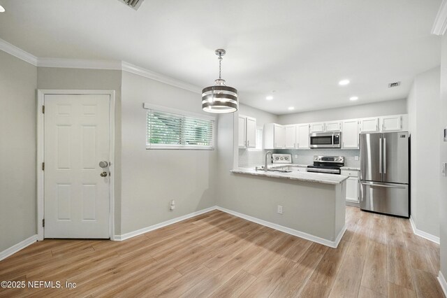 1800 The Greens Way Unit 603, Jacksonville Beach, FL 32250 - kitchen featuring appliances with stainless steel finishes, white cabinetry, a peninsula, light wood-style flooring, and recessed lighting