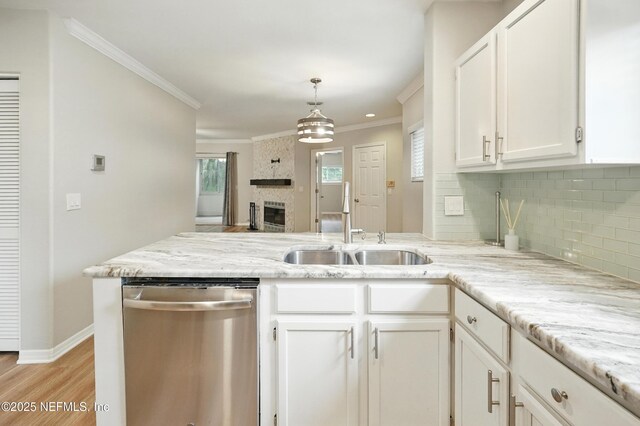 1800 The Greens Way Unit 603, Jacksonville Beach, FL 32250 - kitchen featuring dishwasher, a peninsula, white cabinetry, tasteful backsplash, and light wood-style floors