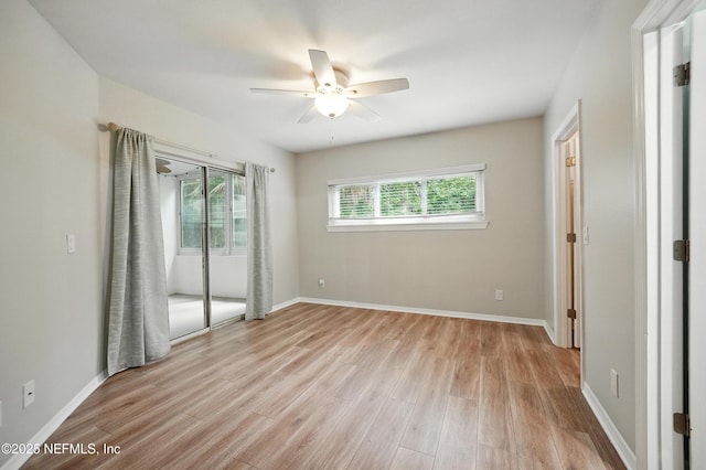 1800 The Greens Way Unit 603, Jacksonville Beach, FL 32250 - unfurnished bedroom featuring multiple windows, light wood-style flooring, and a ceiling fan