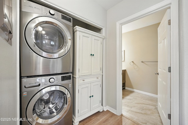 1800 The Greens Way Unit 603, Jacksonville Beach, FL 32250 - washroom with stacked washer / drying machine and cabinet space