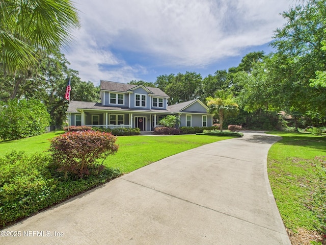 96168 High Pointe Dr, Fernandina Beach, FL 32034 - traditional-style house with driveway, covered porch, and a front yard