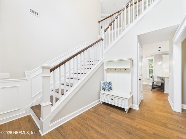 96168 High Pointe Dr, Fernandina Beach, FL 32034 - stairway featuring wood finished floors and a high ceiling