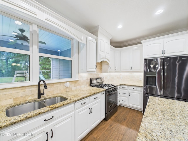 96168 High Pointe Dr, Fernandina Beach, FL 32034 - kitchen with stainless steel fridge with ice dispenser, range with gas stovetop, white cabinets, a ceiling fan, and dark wood-style flooring