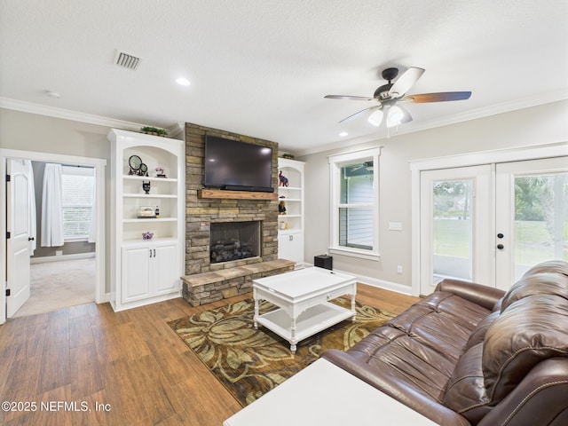 96168 High Pointe Dr, Fernandina Beach, FL 32034 - living room with wood finished floors, a stone fireplace, crown molding, ceiling fan, and recessed lighting