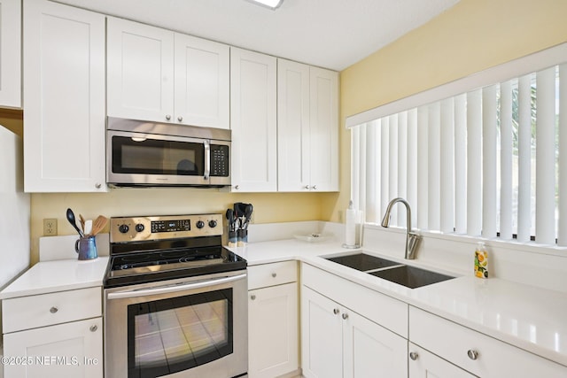 3960 A1A S Unit 505, Saint Augustine Beach, FL 32080 - kitchen featuring appliances with stainless steel finishes, white cabinets, and light countertops