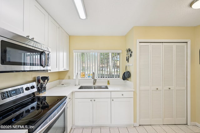 3960 A1A S Unit 505, Saint Augustine Beach, FL 32080 - kitchen featuring appliances with stainless steel finishes, white cabinets, and light countertops