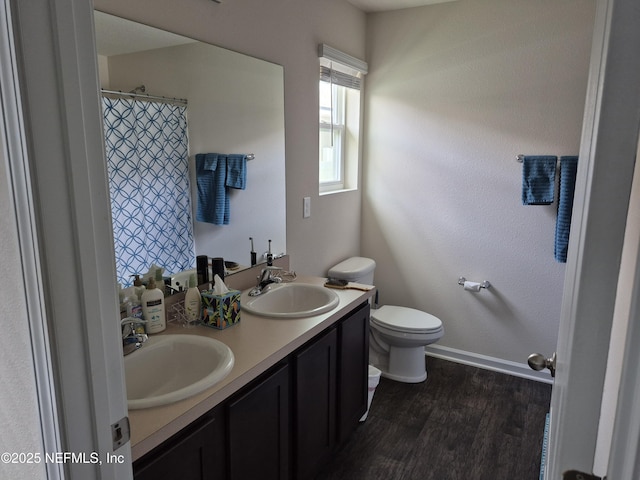 2420 Cold Stream Ln, Green Cove Springs, FL 32043 - bathroom with double vanity, wood finished floors, toilet, and baseboards
