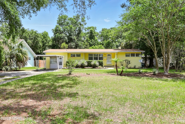 1206 Nightingale Ct, Jacksonville, FL 32216 - single story home featuring a front yard, driveway, and a carport