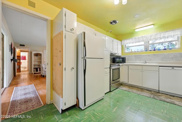 1206 Nightingale Ct, Jacksonville, FL 32216 - kitchen with white appliances, white cabinetry, and light countertops