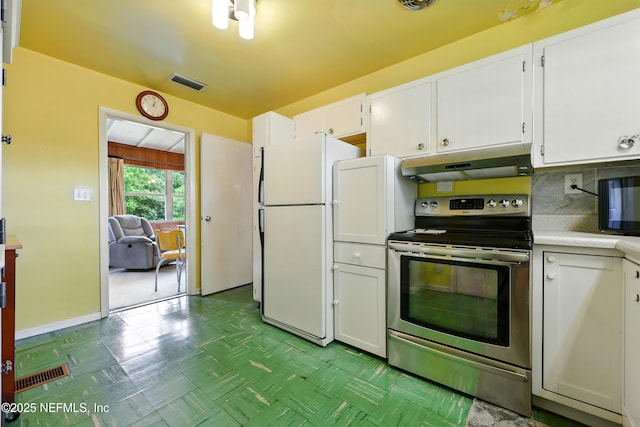 1206 Nightingale Ct, Jacksonville, FL 32216 - kitchen with stainless steel range with electric cooktop, under cabinet range hood, freestanding refrigerator, and white cabinetry