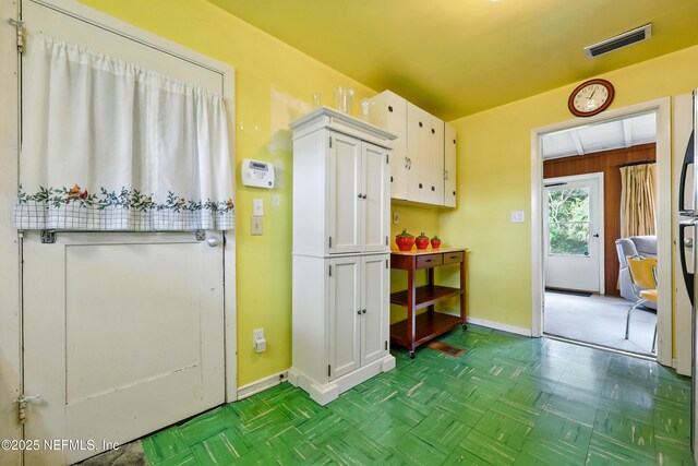 1206 Nightingale Ct, Jacksonville, FL 32216 - kitchen featuring baseboards and white cabinets