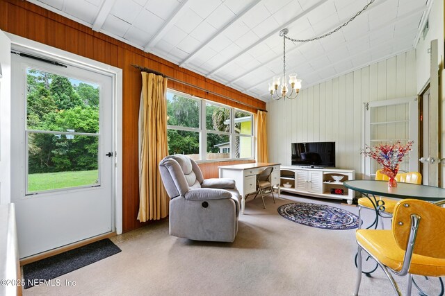 1206 Nightingale Ct, Jacksonville, FL 32216 - living room featuring a chandelier, vaulted ceiling, and wooden walls